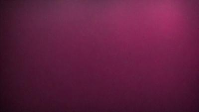 The primary subject of the image is a large, pink wall. The setting is a room with a pink background, and the visual style is a close-up of the wall. The dominant colors in the image are pink, and the overall atmosphere is warm and inviting.