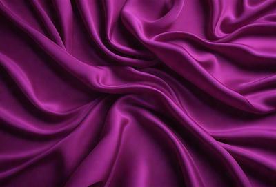 The primary subject of the image is a purple fabric, which is the main object, scene, or focus of the image. The setting or background is a purple curtain, and the visual style is a photo. The colors and mood of the image are predominantly purple, creating a calm and serene atmosphere.