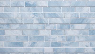 The primary subject of the image is a blue and white marble tile wall. The setting is a room with a blue and white marble tile wall as the main focus. The visual style is a photo of the marble tile wall. The dominant colors are blue and white, creating a clean and elegant atmosphere.