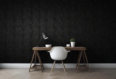The primary subject of the image is a white chair placed on a wooden table. The setting is a room with a black wall, and the visual style is a photo. The colors and mood of the image are predominantly black and white, giving it a classic and elegant appearance.