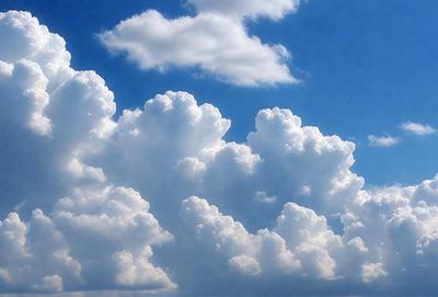 The primary subject of the image is a cloudy sky filled with various cloud formations. The setting is a blue sky, which serves as the backdrop for the clouds. The visual style of the image is a photo, capturing the natural beauty of the cloudy sky. The colors and mood of the image are predominantly blue and serene, with the clouds creating a sense of depth and movement in the sky.