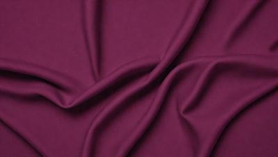 The primary subject of the image is a purple fabric, which is the main object, scene, or focus of the image. The setting/background consists of a purple cloth, and the visual style is a close-up of the fabric. The colors and mood of the image are predominantly purple, creating a calm and soothing atmosphere.