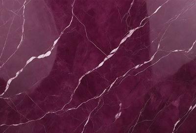The primary subject of the image is a marble wall with a purple hue. The setting is a room with a purple marble wall, and the visual style is a close-up of the marble wall. The colors and mood of the image are predominantly purple, creating a calm and elegant atmosphere.