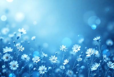 The primary subject of the image is a field of white flowers, which are the main objects in the scene. The setting is a blue sky, creating a serene and peaceful atmosphere. The visual style is a photo, capturing the beauty of the flowers in their natural environment. The colors and mood of the image are predominantly blue, with the white flowers adding a touch of purity and elegance to the scene.