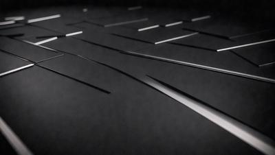 The primary subject of the image is a close-up of a black surface with a pattern of silver lines. The setting appears to be a dark room, and the visual style is a black and white photo. The dominant colors are black and silver, creating a moody and dramatic atmosphere.