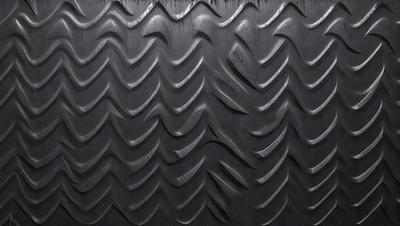 The primary subject of the image is a close-up of a black and gray patterned surface, which appears to be a textured wall or a piece of artwork. The setting is indoors, with the patterned surface being the main focus of the image. The visual style is a combination of photo and digital art, creating a unique and intriguing appearance. The colors and mood of the image are predominantly black and gray, with a slightly dark and moody atmosphere.
