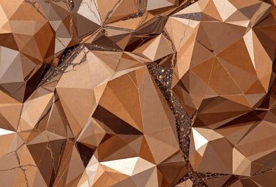 The image features a close-up of a marble surface with a pattern of triangles. The triangles are arranged in a way that creates a visually interesting and unique design. The marble surface appears to be a part of a wall or a floor, and the triangles are the primary subject of the image. The setting is a natural environment, with the marble surface being the main focus of the scene. The visual style of the image is a close-up of the marble surface, showcasing the intricate pattern of
