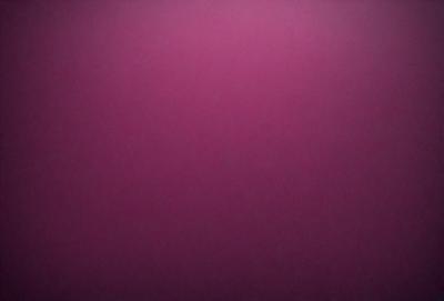 The primary subject of the image is a close-up of a pink wall. The setting is a room with a pink background. The visual style is a photo, and the dominant colors are pink and purple. The overall atmosphere is warm and inviting.