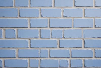 The primary subject of the image is a blue brick wall. The setting is a brick wall with a blue color, and the visual style is a photo. The dominant colors and overall atmosphere are blue and calming.