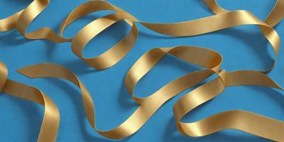 The primary subject of the image is a close-up of a gold ribbon. The ribbon is wound around itself, creating a pattern of intertwined loops. The setting is a blue surface, which provides a contrasting background for the gold ribbon. The visual style of the image is a close-up, focusing on the intricate details of the ribbon. The colors and mood of the image are predominantly gold and blue, giving it a warm and elegant atmosphere.