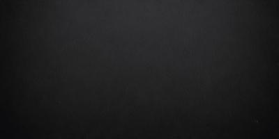 The primary subject of the image is a black background. The setting is a dark room, and the visual style is a black and white photo. The colors and mood of the image are dark and moody, creating a sense of mystery or drama.