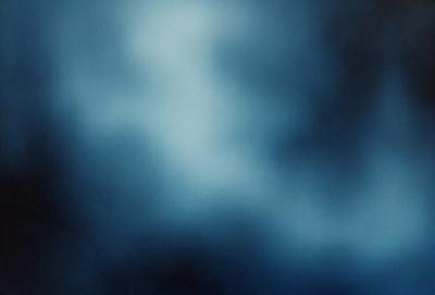 The primary subject of the image is a cloudy blue sky. The setting is a dark, cloudy sky, which creates a moody atmosphere. The visual style is a photo, capturing the beauty of the cloudy sky. The colors and mood are predominantly dark and moody, with the blue hues of the sky being the main focus.