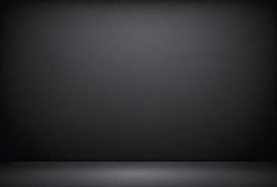 The primary subject of the image is a black background. The setting is a dark room, and the visual style is a black and white photo. The colors and mood of the image are predominantly dark and moody.