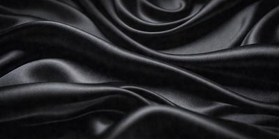 The primary subject of the image is a close-up of a black fabric, possibly a piece of clothing or a curtain. The setting is a dark background, which emphasizes the fabric's texture and appearance. The visual style is a close-up, focusing on the details of the fabric. The colors and mood of the image are predominantly dark, with the black fabric being the main focus.