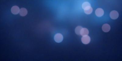 The primary subject of the image is a blue sky filled with bright, white, and pink lights. The setting is a night sky, and the visual style appears to be a photo. The colors and mood of the image are vibrant and lively, with the bright lights creating a captivating atmosphere.