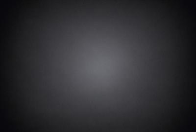 The image is a black and white photo of a dark, empty room. The room appears to be a large, open space with no visible furniture or decorations. The overall atmosphere is one of emptiness and simplicity.