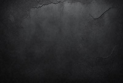 The primary subject of the image is a black and white photo of a wall. The setting is a concrete wall, and the visual style is a black and white photo. The colors and mood of the image are predominantly black and white, creating a stark and dramatic atmosphere.
