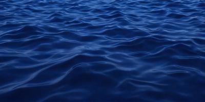 The primary subject of the image is a large body of blue water, which appears to be a deep blue ocean. The setting is a vast expanse of water, with no visible land or other objects in the background. The visual style of the image is a realistic representation of the ocean, with no indication of digital manipulation or artistic alteration. The dominant colors in the image are blue and black, creating a serene and calming atmosphere.