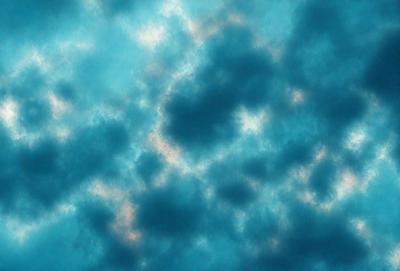The primary subject of the image is a cloudy blue sky. The setting is a cloudy day, and the visual style is a photo. The sky is filled with clouds, creating a moody atmosphere.
