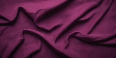 The primary subject of the image is a purple fabric, which is the main object, scene, or focus of the image. The setting or background of the image is a purple sheet, and the visual style is a close-up of the purple fabric. The colors and mood of the image are predominantly purple, creating a calm and soothing atmosphere.