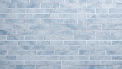 The primary subject of the image is a blue brick wall. The setting is a room with a blue brick wall as the main focus. The visual style is a photo of the brick wall. The dominant colors are blue and white, creating a calm and soothing atmosphere.