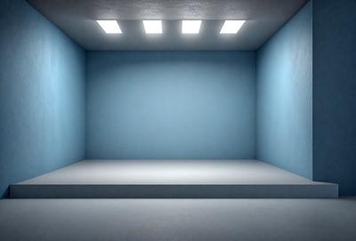 The primary subject of the image is a large, empty room with a blue wall. The setting is a white room with a blue wall, and the visual style is a photo. The colors and mood of the image are predominantly blue, creating a calm and serene atmosphere.