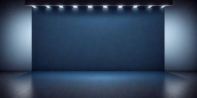 The primary subject of the image is a blue wall with a blue background. The setting is a dark room with a blue stage. The visual style is a photo, and the colors and mood are predominantly blue, creating a calm and serene atmosphere.