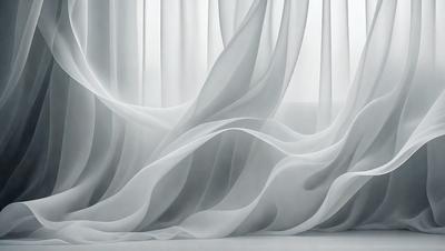 The primary subject of the image is a curtain, which is the main object in the scene. The curtain is white and appears to be billowing or flowing, giving the impression of a gentle breeze. The setting is a room with a couch visible in the background. The visual style of the image is a photo, capturing the curtain's movement and texture. The colors and mood of the image are predominantly white, creating a serene and calming atmosphere.