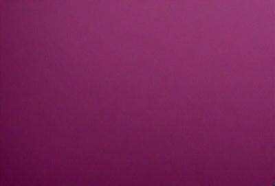 The primary subject of the image is a large, purple wall. The setting is a room with a pink background. The visual style is a close-up of the purple wall, which gives a sense of depth and texture. The colors and mood of the image are predominantly pink, creating a warm and inviting atmosphere.