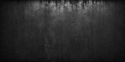 The primary subject of the image is a black and white photo of a wall. The setting is a room with a wall that appears to be dirty or worn. The visual style is a black and white photo, which gives the image a classic and timeless appearance. The colors and mood of the image are predominantly dark and moody, with the black and white tones adding to the overall atmosphere.