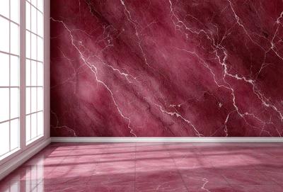 The primary subject of the image is a marble wall with a pink marble texture. The setting is a room with a pink marble floor. The visual style is a photo of the marble wall and floor. The dominant colors are pink and red, creating a warm and inviting atmosphere.