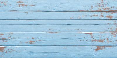 The primary subject of the image is a wooden surface with a blue background. The setting appears to be a room with a blue wall. The visual style is a photo, and the dominant colors are blue and orange. The overall atmosphere is calm and serene.
