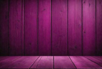 The primary subject of the image is a purple wooden wall. The setting is a room with a wooden floor. The visual style is a photo, and the dominant colors are purple and brown. The overall atmosphere is calm and inviting.