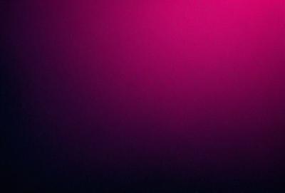 The primary subject of the image is a purple wall. The setting is a room with a purple wall, and the visual style is a photo. The dominant colors in the image are purple and pink, creating a warm and inviting atmosphere.