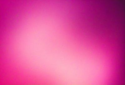 The primary subject of the image is a pink background. The setting is a pink wall, and the visual style is a close-up of the pink wall. The colors and mood of the image are predominantly pink, creating a warm and inviting atmosphere.
