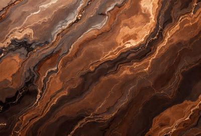 The primary subject of the image is a close-up of a marble-like stone with a brown and orange color palette. The setting is a natural environment, possibly a rock formation or a stone wall. The visual style is a close-up of the stone, showcasing its texture and intricate patterns. The colors and mood of the image are warm and earthy, evoking a sense of natural beauty and richness.