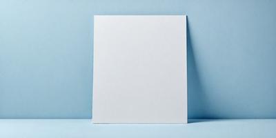 The primary subject of the image is a white piece of paper. The setting is a blue surface, which could be a table or a wall. The visual style is a photo, and the colors and mood are predominantly blue and calm.