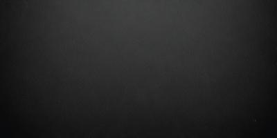 The primary subject of the image is a black background. The setting is a dark room, and the visual style is a black and white photo. The colors and mood of the image are dark and moody, creating a sense of mystery or drama.