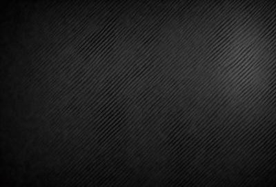 The primary subject of the image is a black background with a pattern of white stripes. The setting is a dark room, and the visual style is a black and white photo. The dominant colors are black and white, creating a moody and dramatic atmosphere.