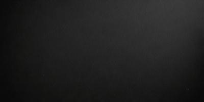 The primary subject of the image is a black background. The setting is a dark room, and the visual style is a black and white photo. The colors and mood of the image are predominantly dark and moody, creating a dramatic and intense atmosphere.
