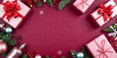 The primary subject of the image is a red background with a circle shape. The setting is a Christmas scene, featuring a wreath and berries. The visual style is a combination of photo and digital art, creating a festive and holiday atmosphere. The dominant colors are red and green, with the red background and green berries, while the overall mood is joyful and celebratory.