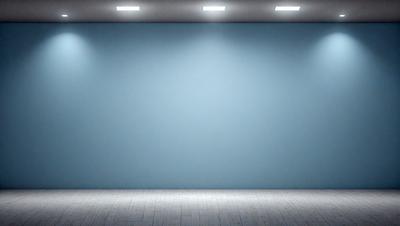 The primary subject of the image is a large, empty blue wall. The setting is a room with a blue background, and the visual style is a photo. The colors and mood of the image are predominantly blue, creating a calm and serene atmosphere.