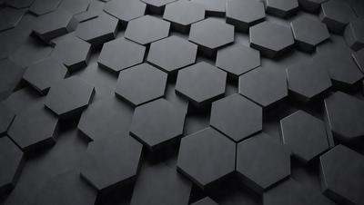 The primary subject of the image is a black and white patterned surface, which appears to be a wall or a piece of artwork. The setting is a dark room, and the visual style is a close-up of the patterned surface. The colors and mood of the image are predominantly dark and moody, with the black and white pattern creating a sense of depth and intrigue.