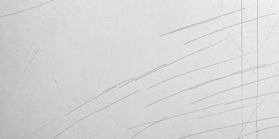 The primary subject of the image is a white wall with a drawing or pattern on it. The setting is a room with a white wall, and the visual style appears to be a combination of drawing and pattern. The colors and mood of the image are predominantly white, giving it a clean and minimalist appearance.