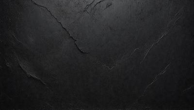 The primary subject of the image is a black leather surface. The setting is a dark room, and the visual style is a close-up of the leather surface. The colors and mood of the image are predominantly dark and moody, with the black leather creating a dramatic and intense atmosphere.