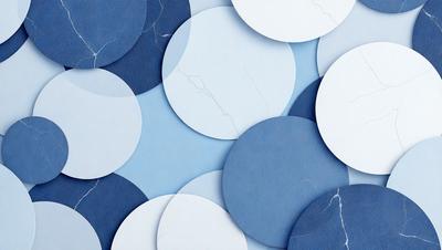 The primary subject of the image is a collection of white and blue circles arranged in a visually appealing manner. The setting is a blue background, which adds a sense of depth and contrast to the circles. The visual style is a combination of digital art and illustration, creating a unique and eye-catching pattern. The dominant colors are white and blue, which evoke a sense of calmness and tranquility.