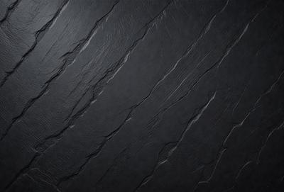The primary subject of the image is a black wall with a pattern of cracks and crevices. The setting is a dark room, and the visual style appears to be a close-up of the wall. The dominant colors are black and grey, creating a moody atmosphere.