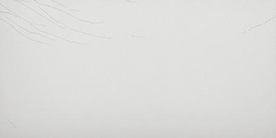 The primary subject of the image is a white canvas with a few black lines on it. The setting is a white background, and the visual style appears to be a drawing or a painting. The colors in the image are predominantly white, with the black lines adding contrast. The overall atmosphere of the image is minimalistic and artistic.