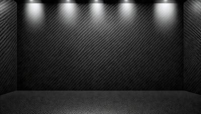 The primary subject of the image is a black and white photo of a stage with a black background. The setting is a stage with a curtain, and the visual style is a black and white photo. The colors and mood of the image are predominantly black and white, creating a dramatic and moody atmosphere.