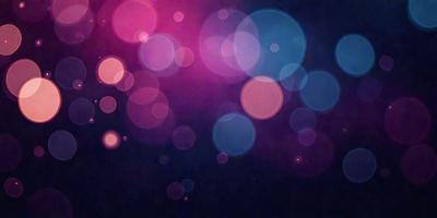 The primary subject of the image is a brightly colored, pink and blue background with a pattern of circles. The setting is a dark background, which contrasts with the vibrant colors of the circles. The visual style is a combination of digital art and illustration, creating a unique and eye-catching design. The colors and mood of the image are lively and energetic, with the bright pink and blue circles adding a sense of excitement and playfulness to the scene.